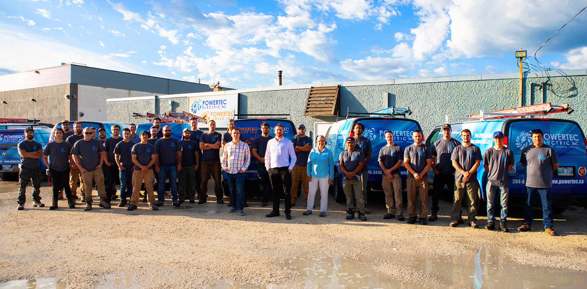 powertec solar team members in front of the vehicles